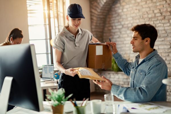 Fast UK Couriers driver handing over a signed-for parcel